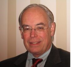 Headshot of Daniel Hanley, MD, BIOS division director in a black suit jacket and red tie.